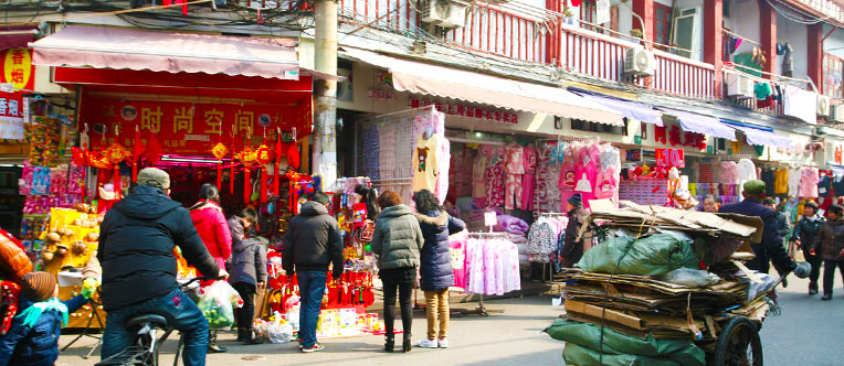 Compare the old street in Shanghai with its modern profile