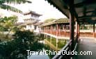 The long covered corridor over the lake leads to a pavilion, Li Garden, Wuxi.