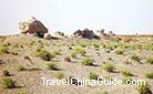 Several blocks of the wall relics of the Han Dynasty dotted in the Gobi Desert.