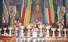 Photos and statue, electrical lamps and butter lamps coexist in this traditional monastery.