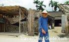 A local woman of Sanya in blue dress looks like a model showing her costume on the runaway.