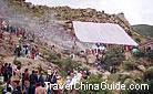 Buddha unfolding is a holy and magic activity in Tibetan. It is said no matter how bad the weather is, the sky will clear up quickly as soon as the painting is unfolded.