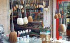 A small shop sells various kinds of brushes on the Cultural Street of Shuyuanmen.