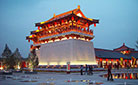 A shinning tower stands outside the West Gate of the Paradise in the dusk.