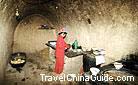 A woman is preparing a meal in the farmer's cave.