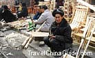 People selling various kinds of woodwork at Kaili market, Guizhou.