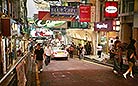 Hong Kong's night life is busy and exciting. People strolling on the streets are looking for a place to enjoy themselves.