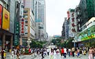 This is a busy commercial street around Jiefangbei in Chongqing. Every moment of every day, the street is brilliant with people coming and going.