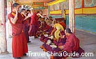 Lamas are debating at the sutra-debating hall in the monastery.