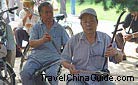 The locals are performing traditional instrument- Erhu.