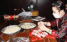 A worker is filling spice to scented sachets that is popular in the Dragon Boat Festival in China.