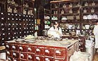 A worker is weighing the medicine and dispensing medication