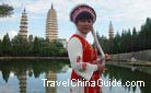 A local Bai nationality lady is taking photo with the pagodas.