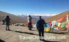 Snow covered Mt. Everest in the far distance and colorful prayer flags in the near distance form a unique scene of Tibet.