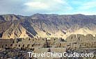 The remains of the ancient Stone City against the grand mountains and the clean sky