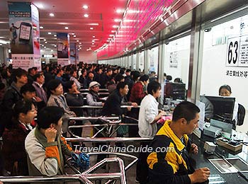 Passengers Queue to Buy Train Tickets